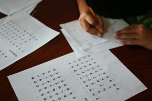 A boy tries to write Japanese characters